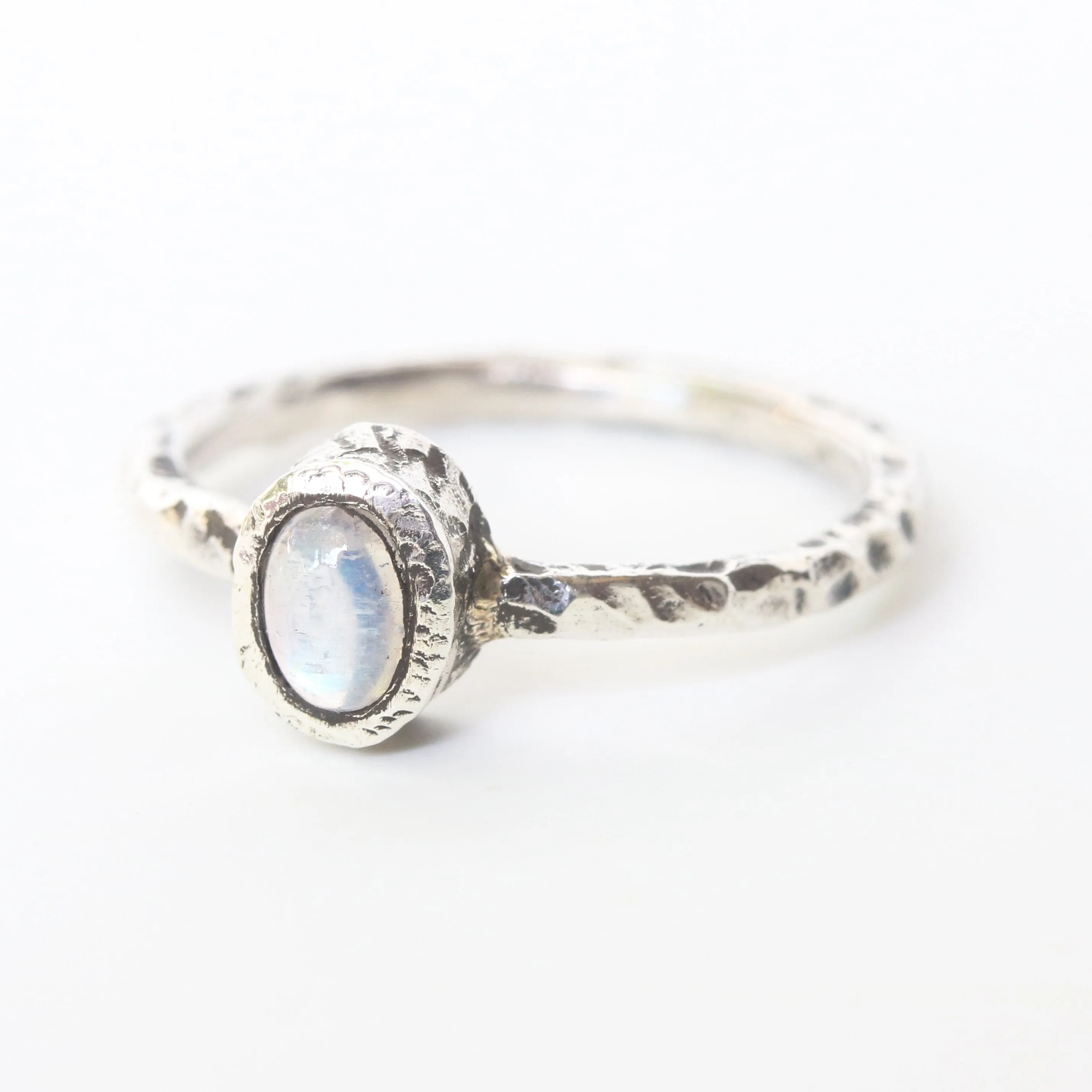 Dainty oval moonstone ring in silver bezel setting with oxidized texture sterling silver band