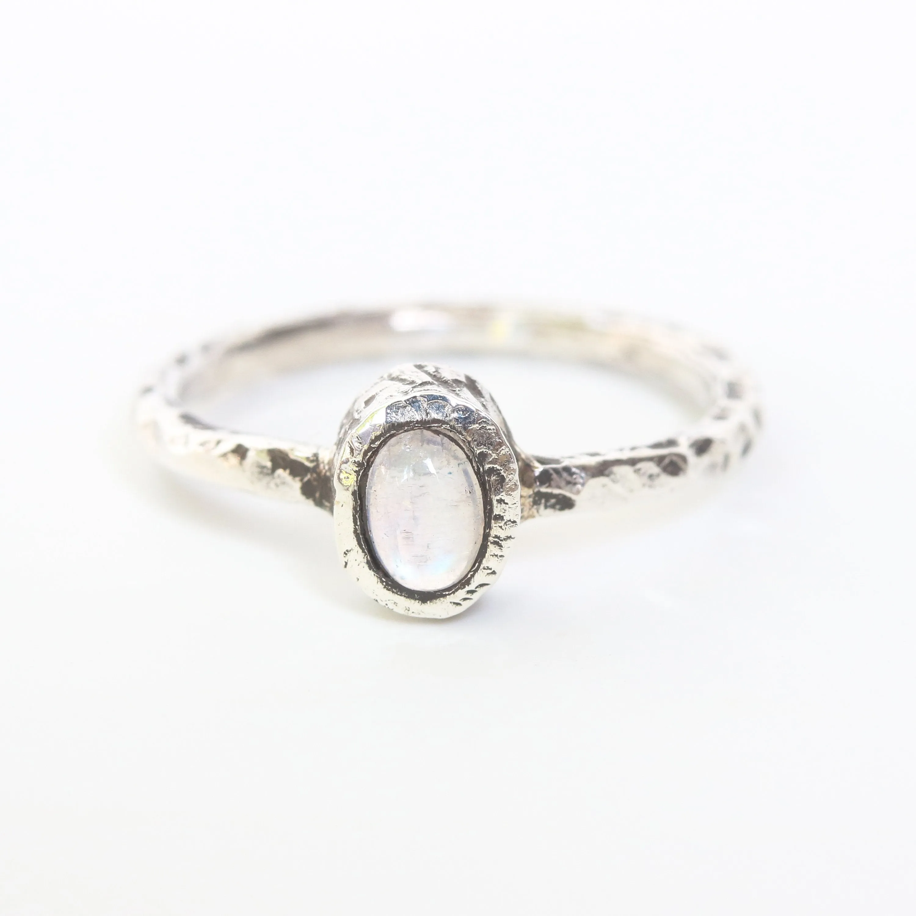Dainty oval moonstone ring in silver bezel setting with oxidized texture sterling silver band