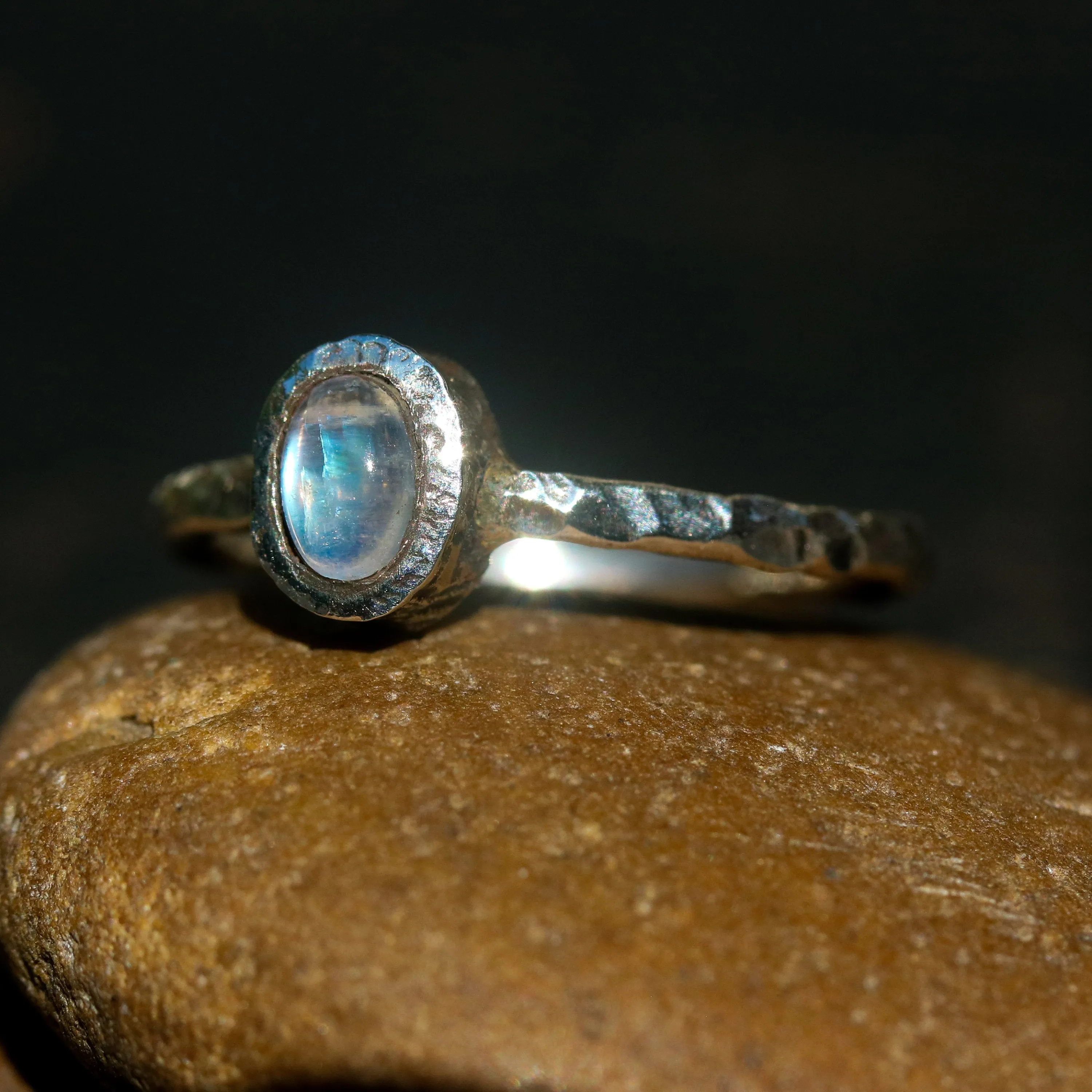 Dainty oval moonstone ring in silver bezel setting with oxidized texture sterling silver band
