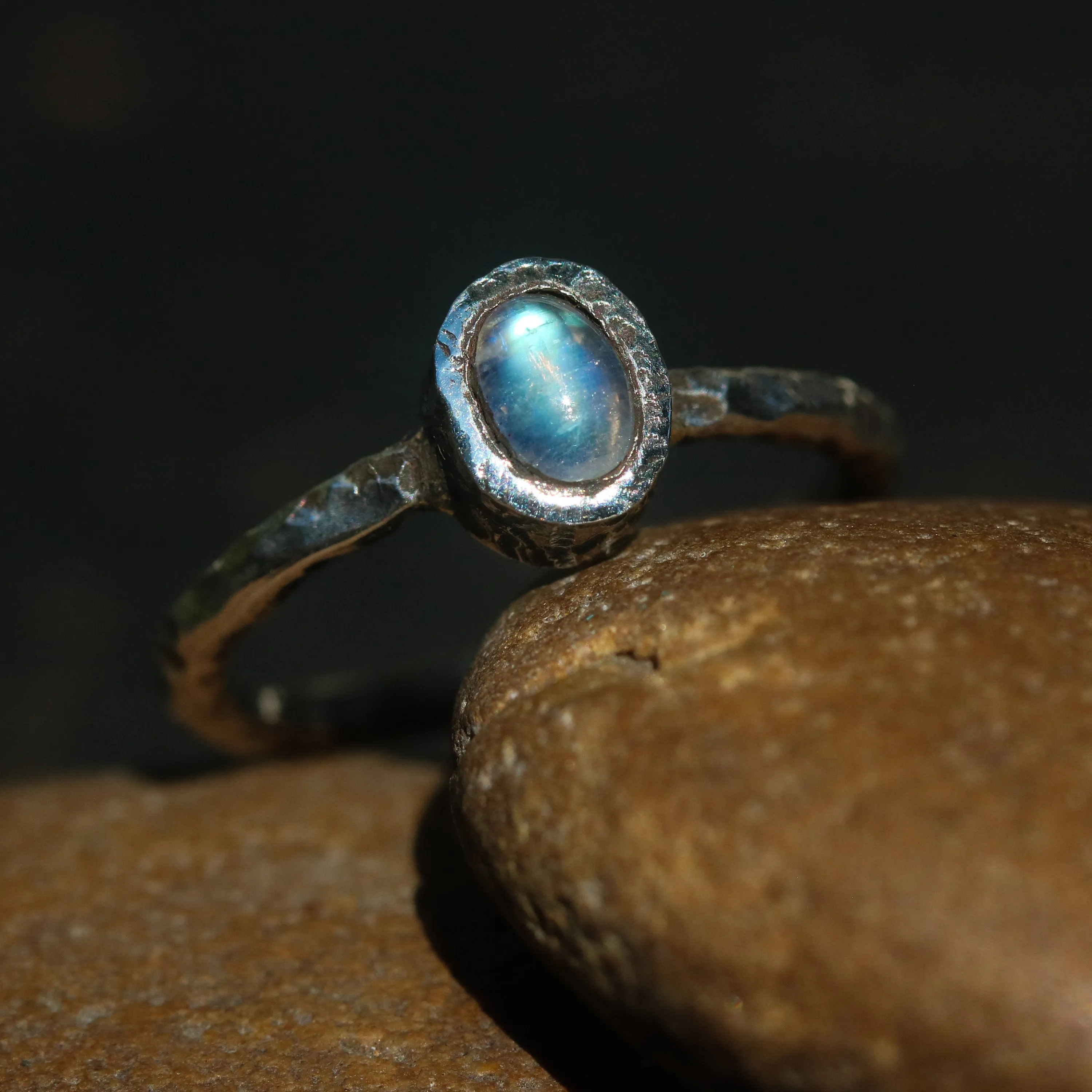 Dainty oval moonstone ring in silver bezel setting with oxidized texture sterling silver band