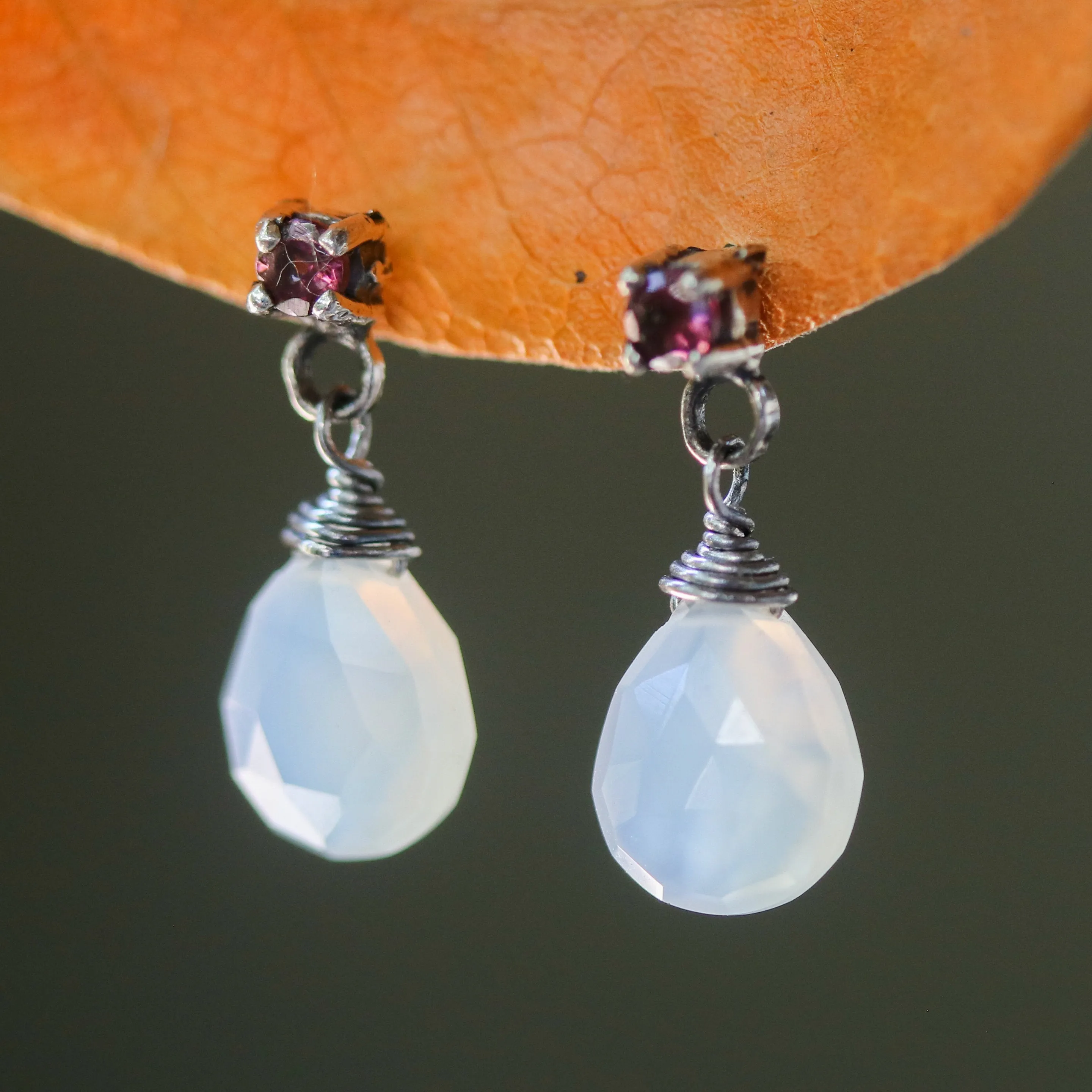 Dyed white chalcedony teardrop faceted earrings with tiny pink tourmaline on the top and sterling silver stud style