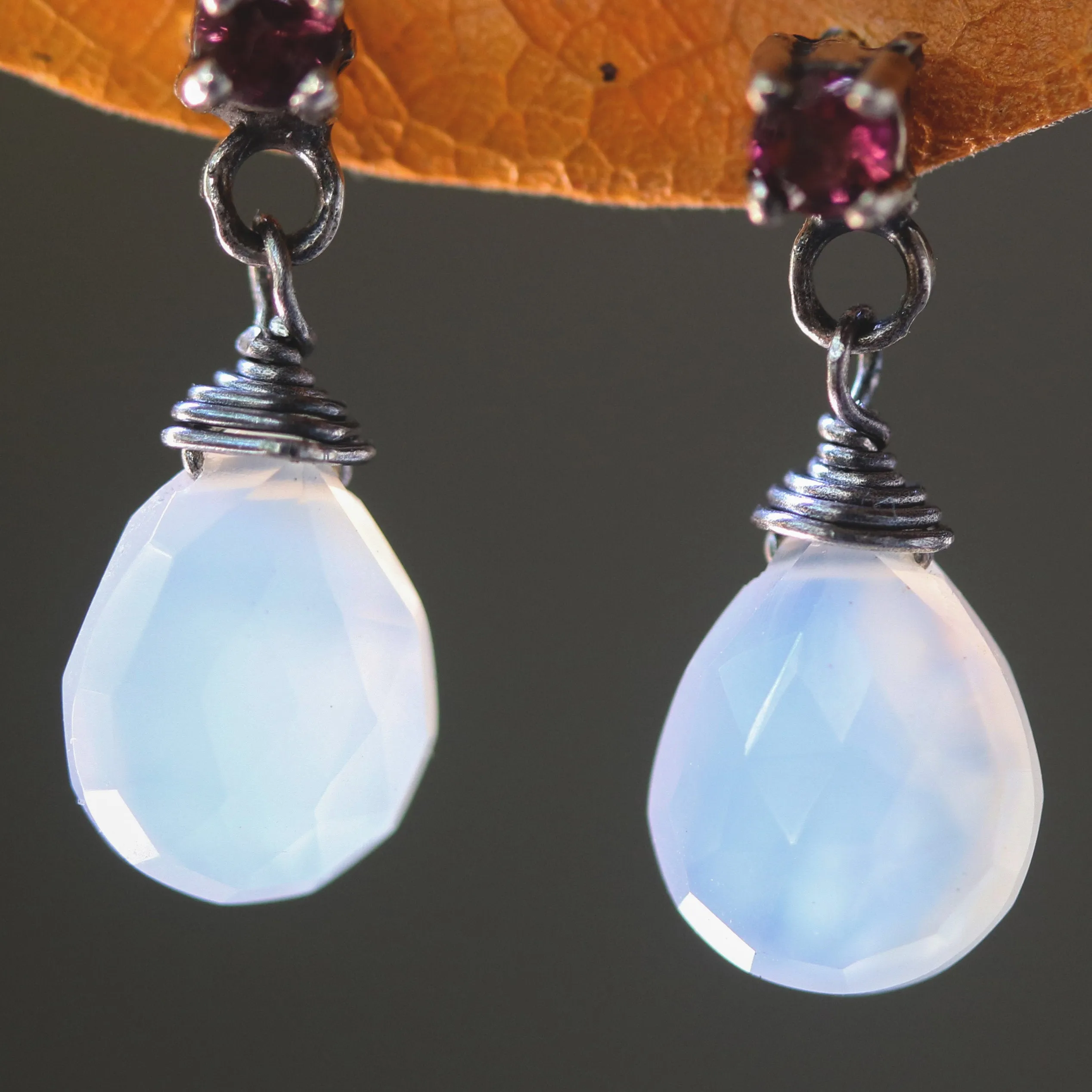 Dyed white chalcedony teardrop faceted earrings with tiny pink tourmaline on the top and sterling silver stud style
