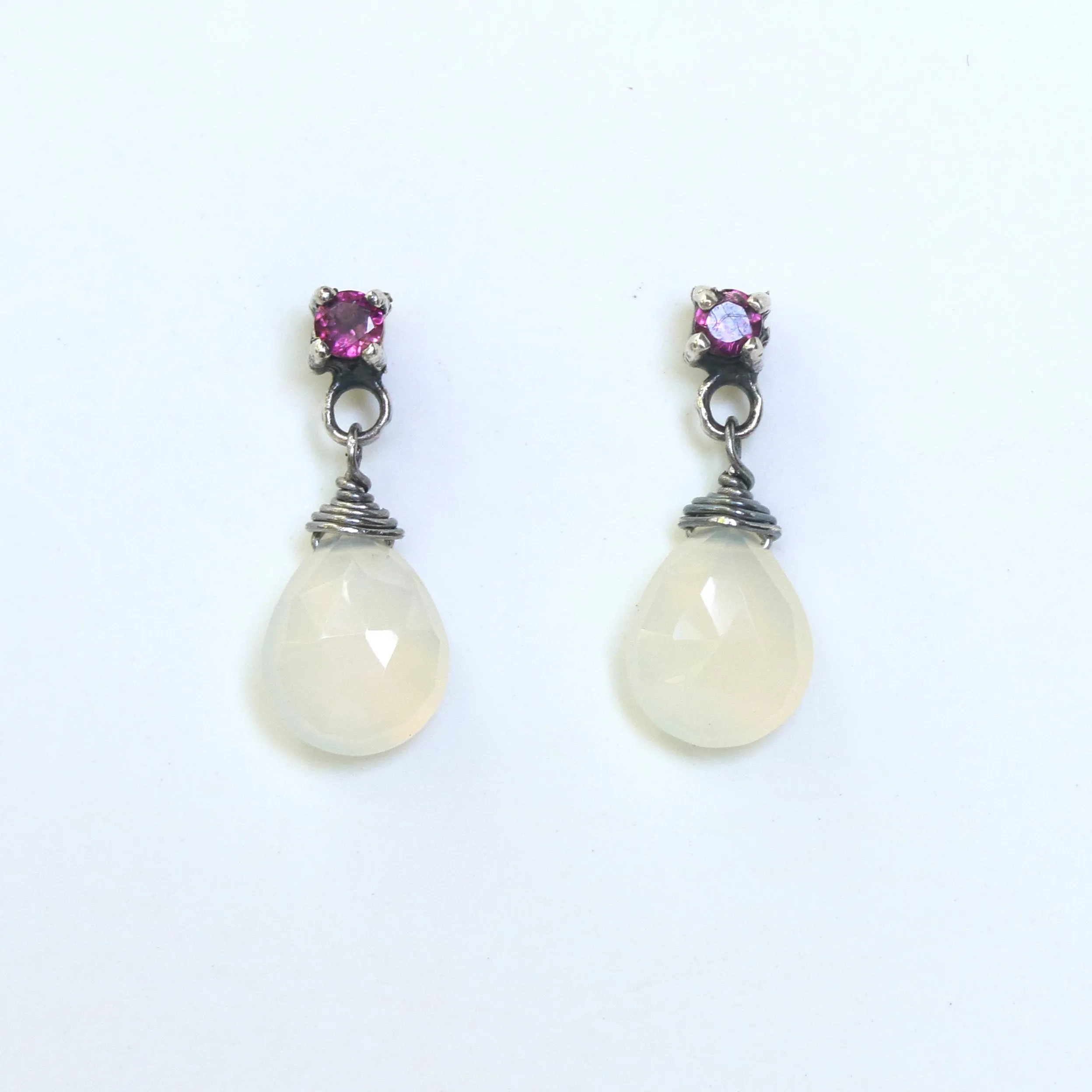 Dyed white chalcedony teardrop faceted earrings with tiny pink tourmaline on the top and sterling silver stud style