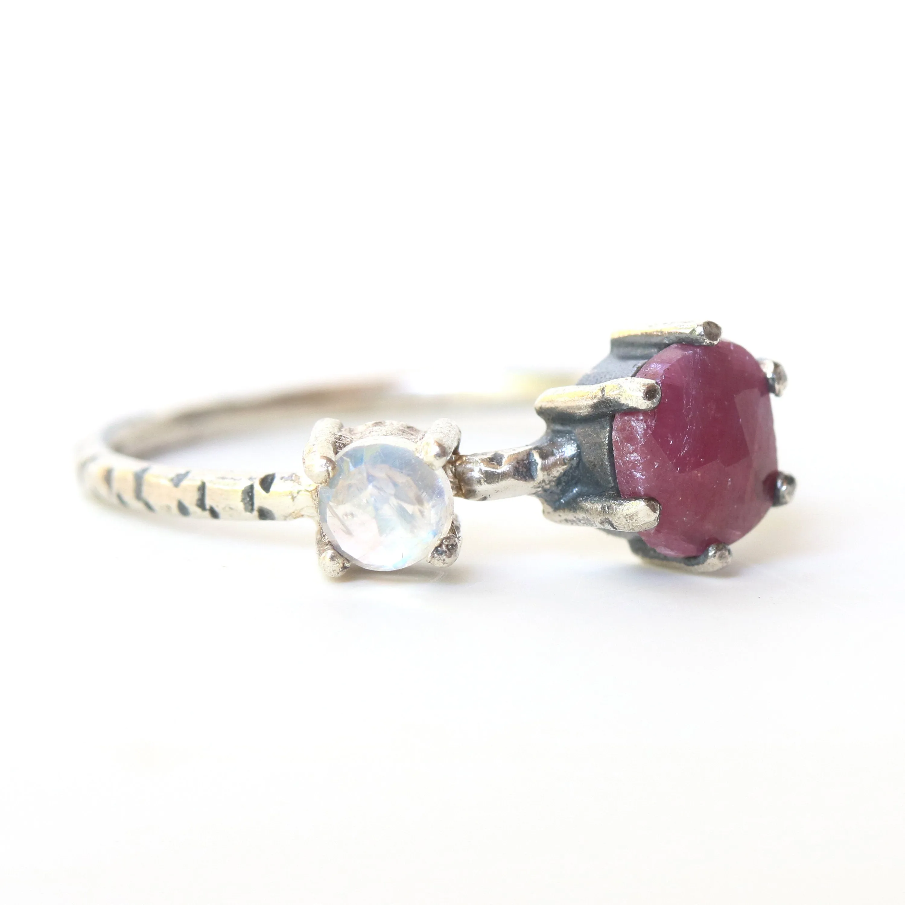 Faceted ruby ring in silver prongs setting and faceted moonstone with sterling silver texture band