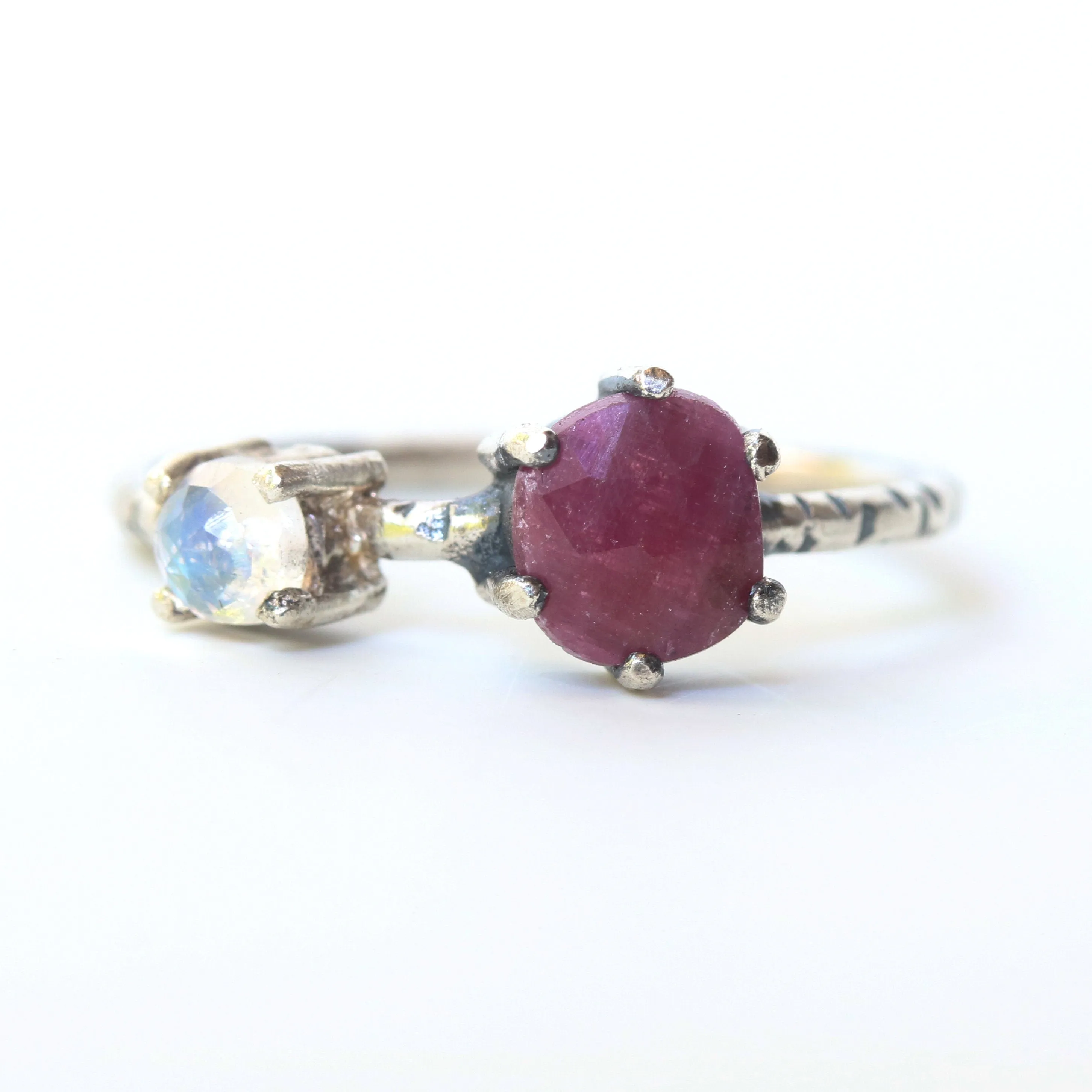 Faceted ruby ring in silver prongs setting and faceted moonstone with sterling silver texture band
