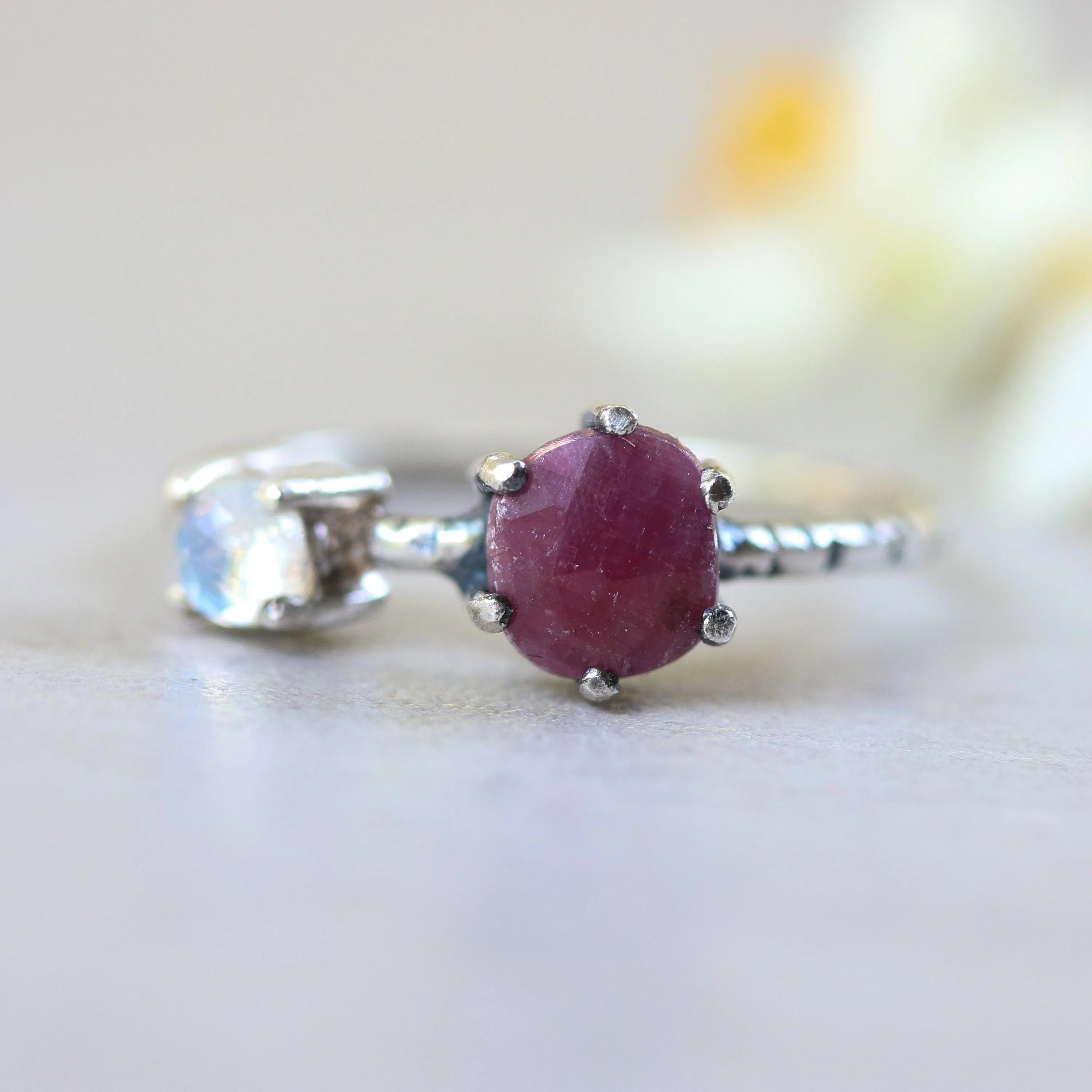 Faceted ruby ring in silver prongs setting and faceted moonstone with sterling silver texture band