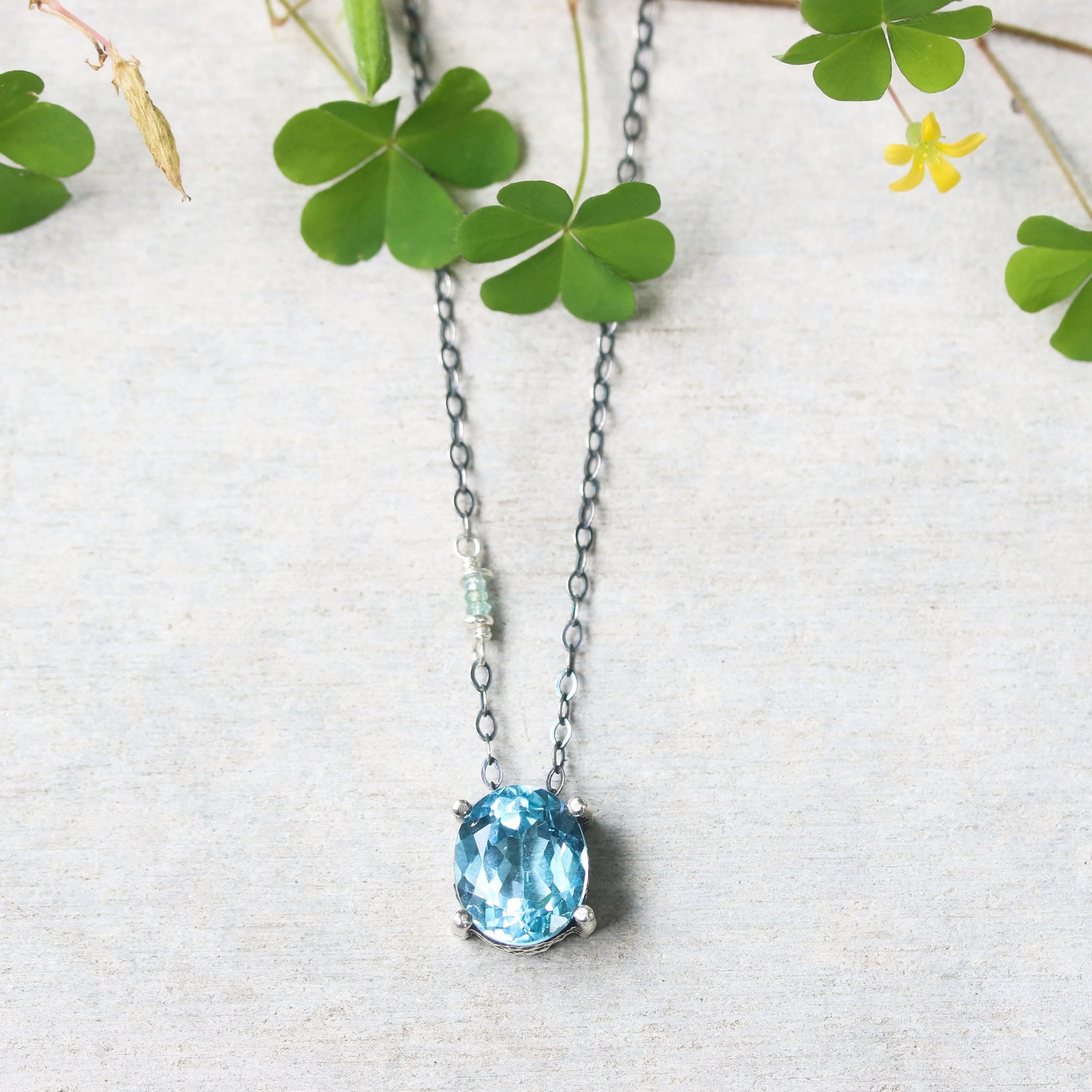 Oval Blue topaz pendant necklace in silver bezel and prongs setting with aquamarine beads secondary on oxidized sterling silver chain
