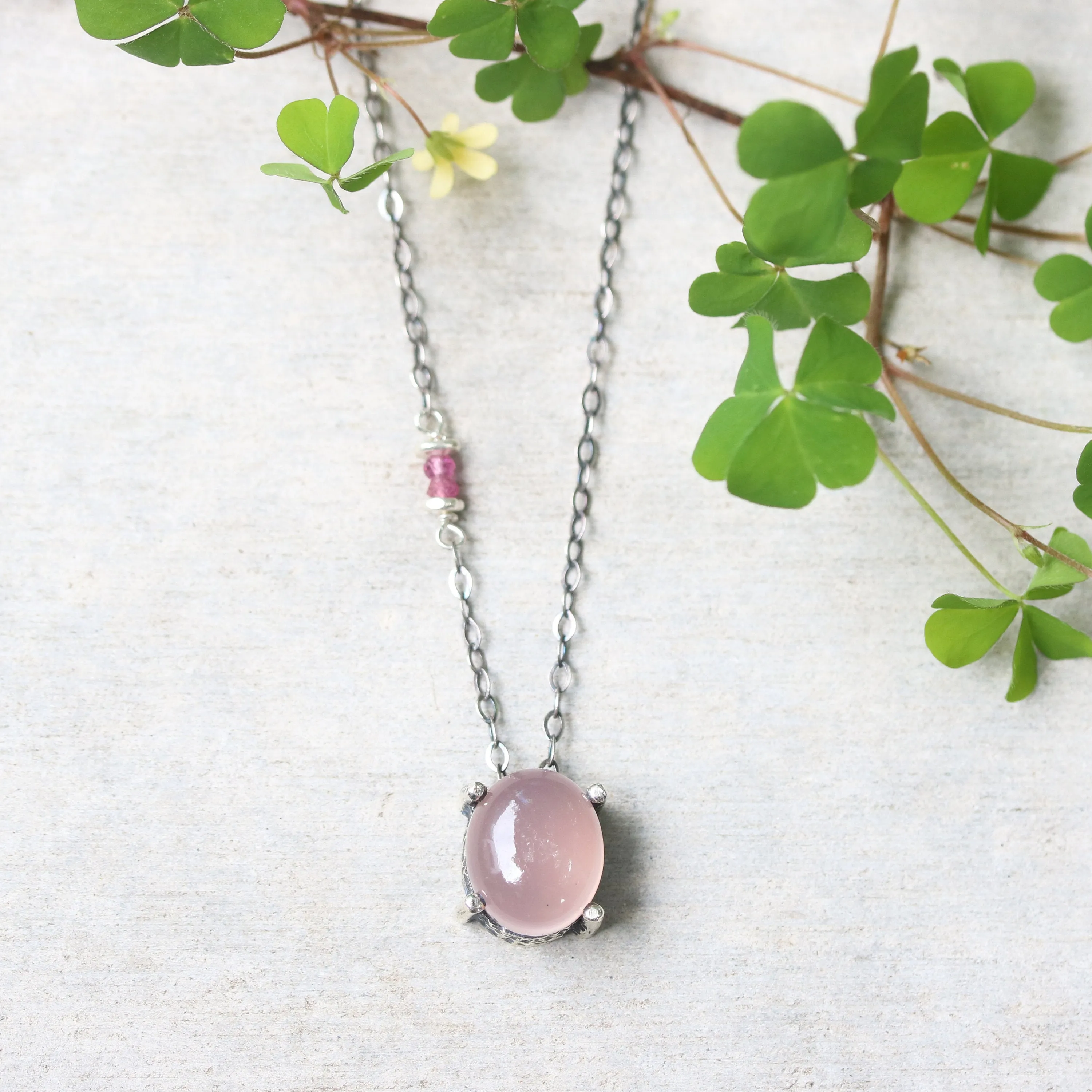 Oval cabochon rose quartz necklace in silver bezel and prongs setting with pink multi-sapphire beads secondary on oxidized silver chain