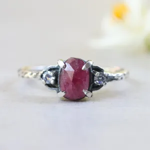 Oval ruby ring with tiny round faceted moonstone side set gems in prongs setting