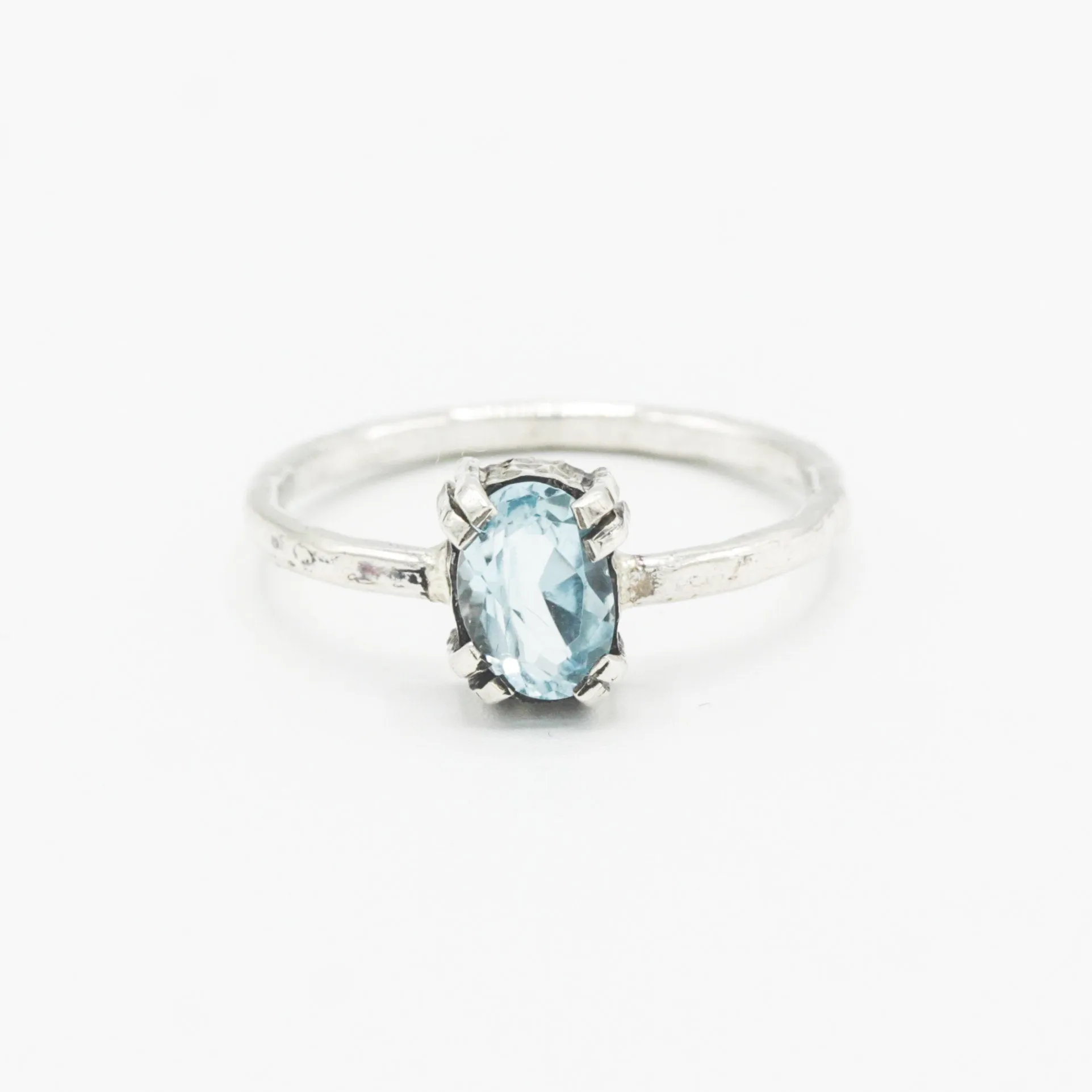Oval Swiss blue topaz ring in silver bezel and prongs setting with sterling silver band