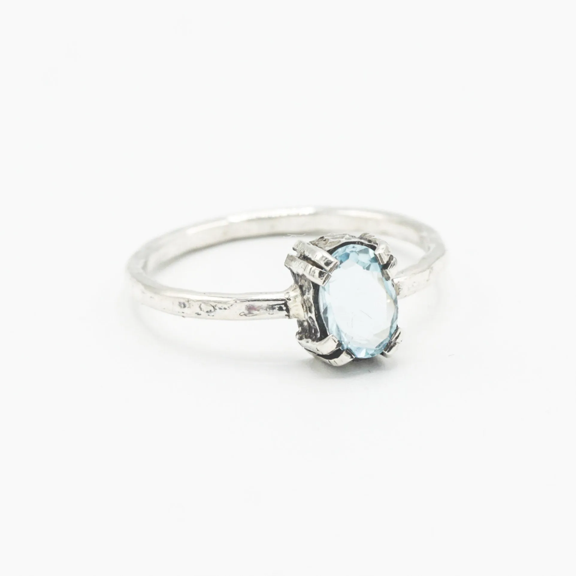 Oval Swiss blue topaz ring in silver bezel and prongs setting with sterling silver band