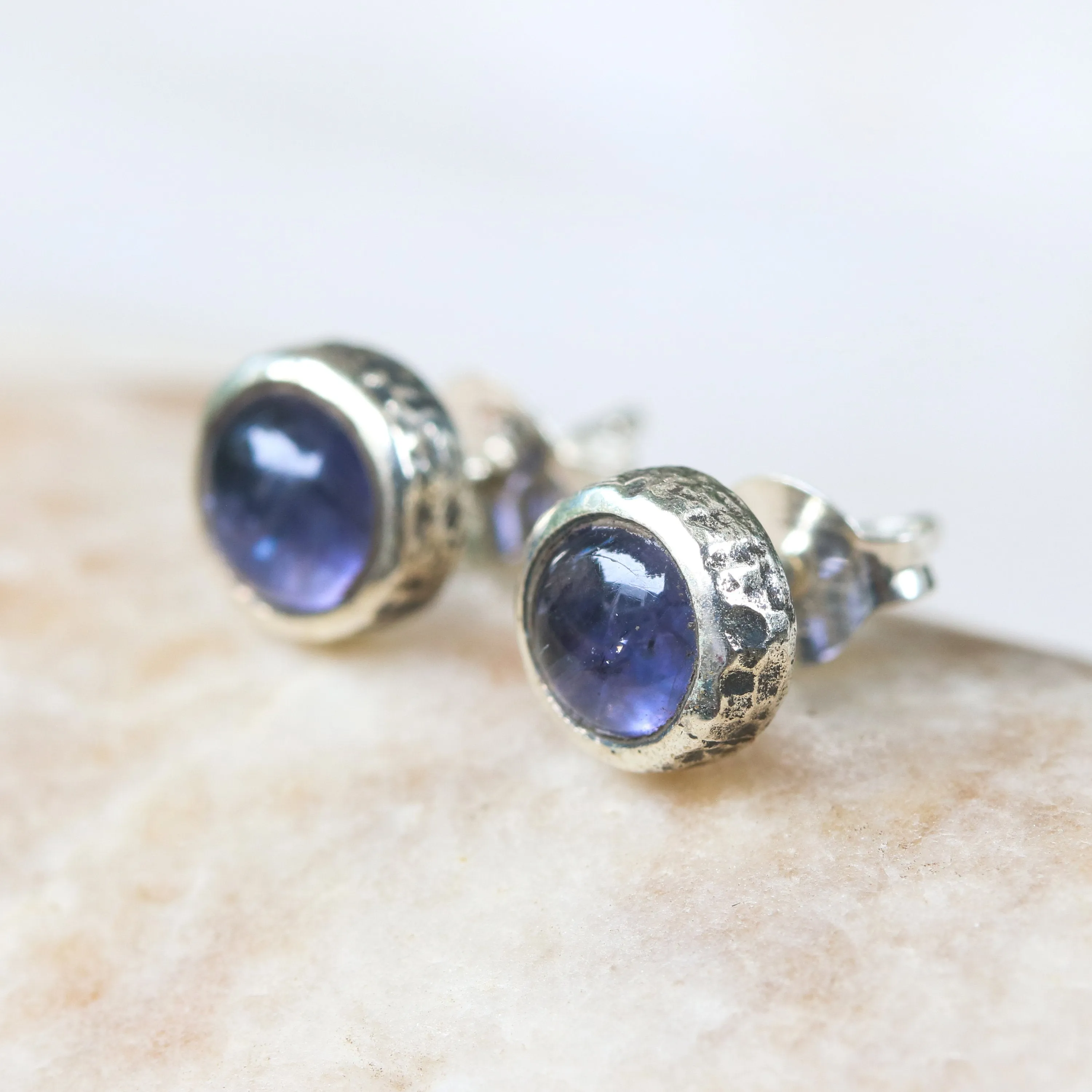 Round cabochon Iolite earrings in silver bezel setting with sterling silver post and backing