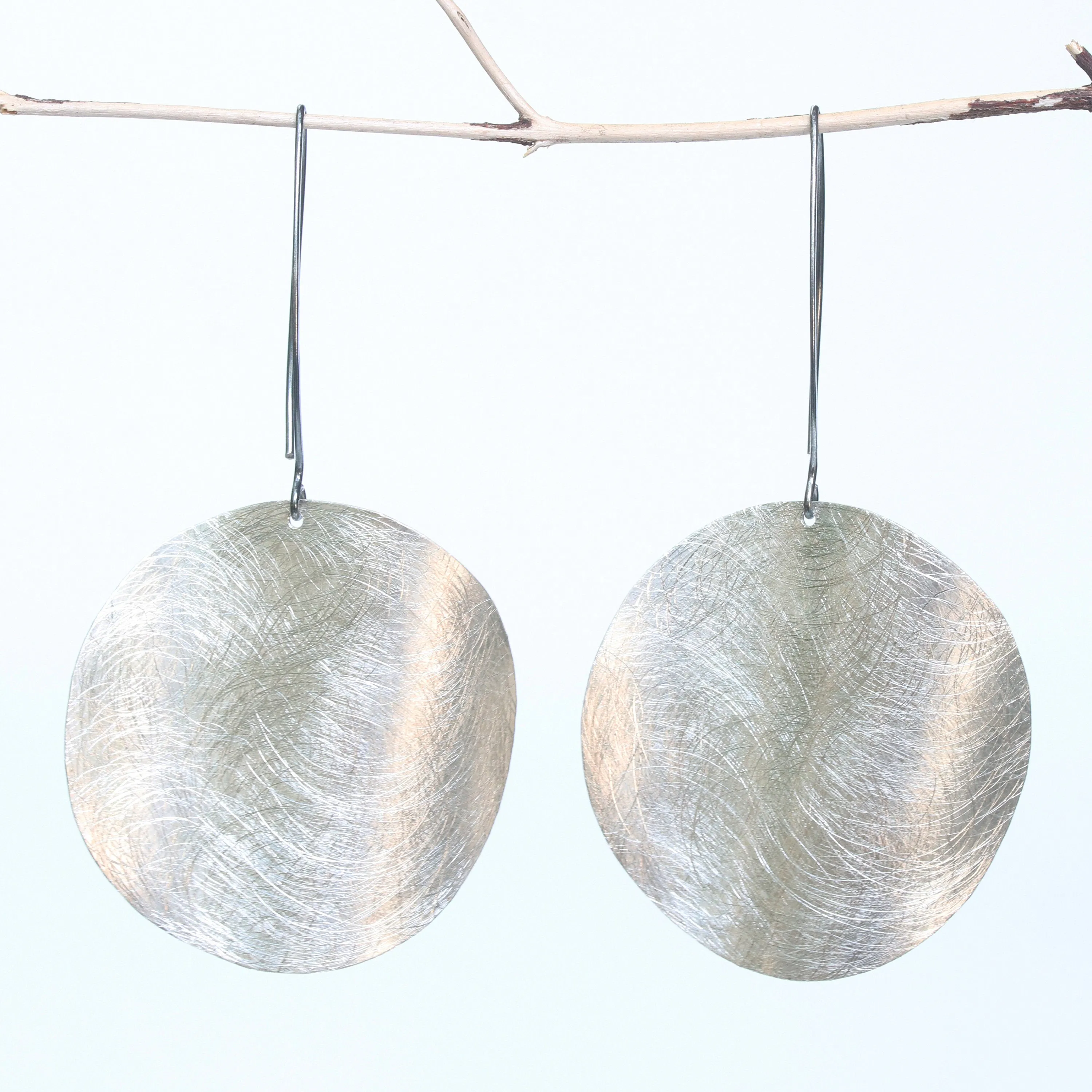 Silver circle earrings with scratched technique texture on sterling silver marquise ear wires hook style