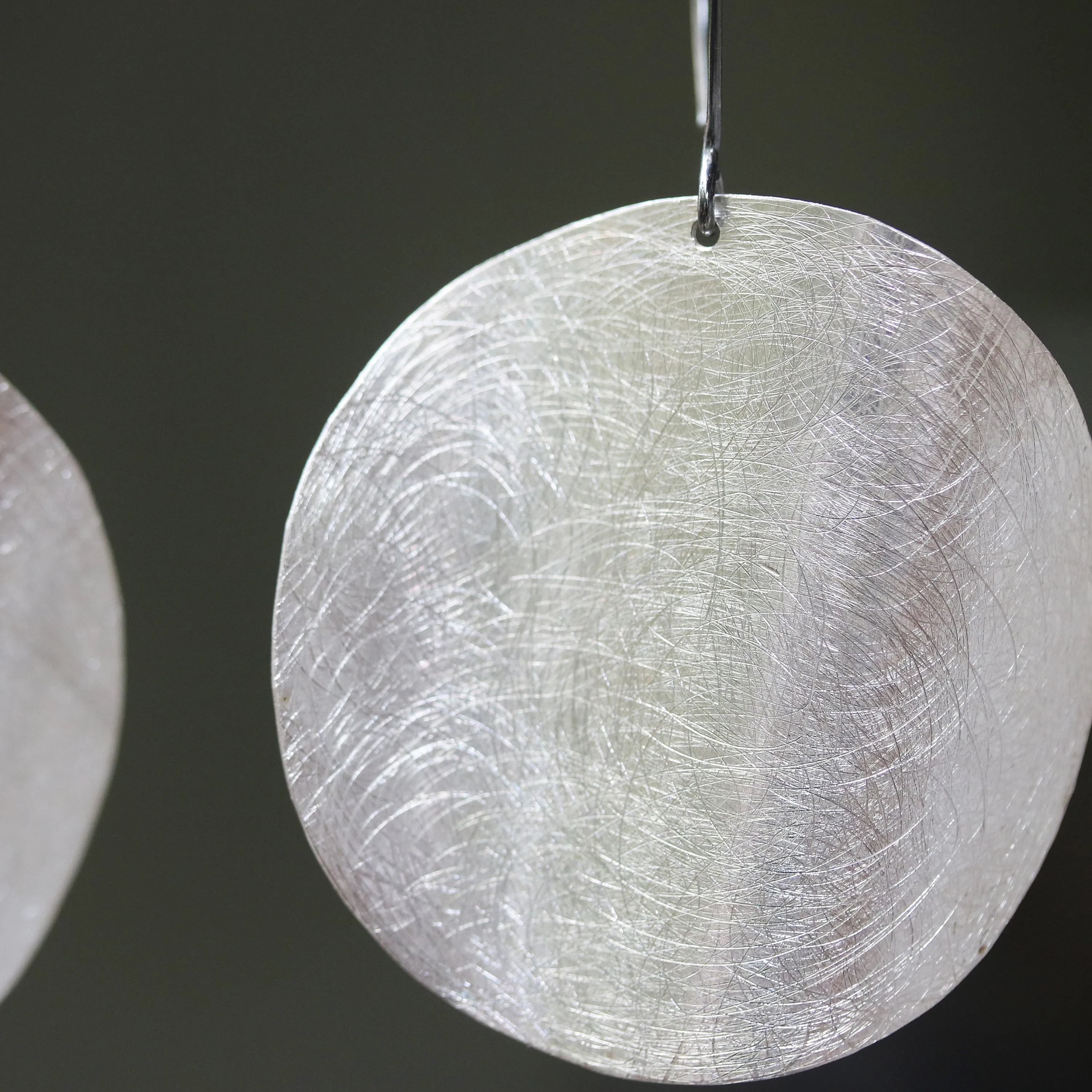 Silver circle earrings with scratched technique texture on sterling silver marquise ear wires hook style