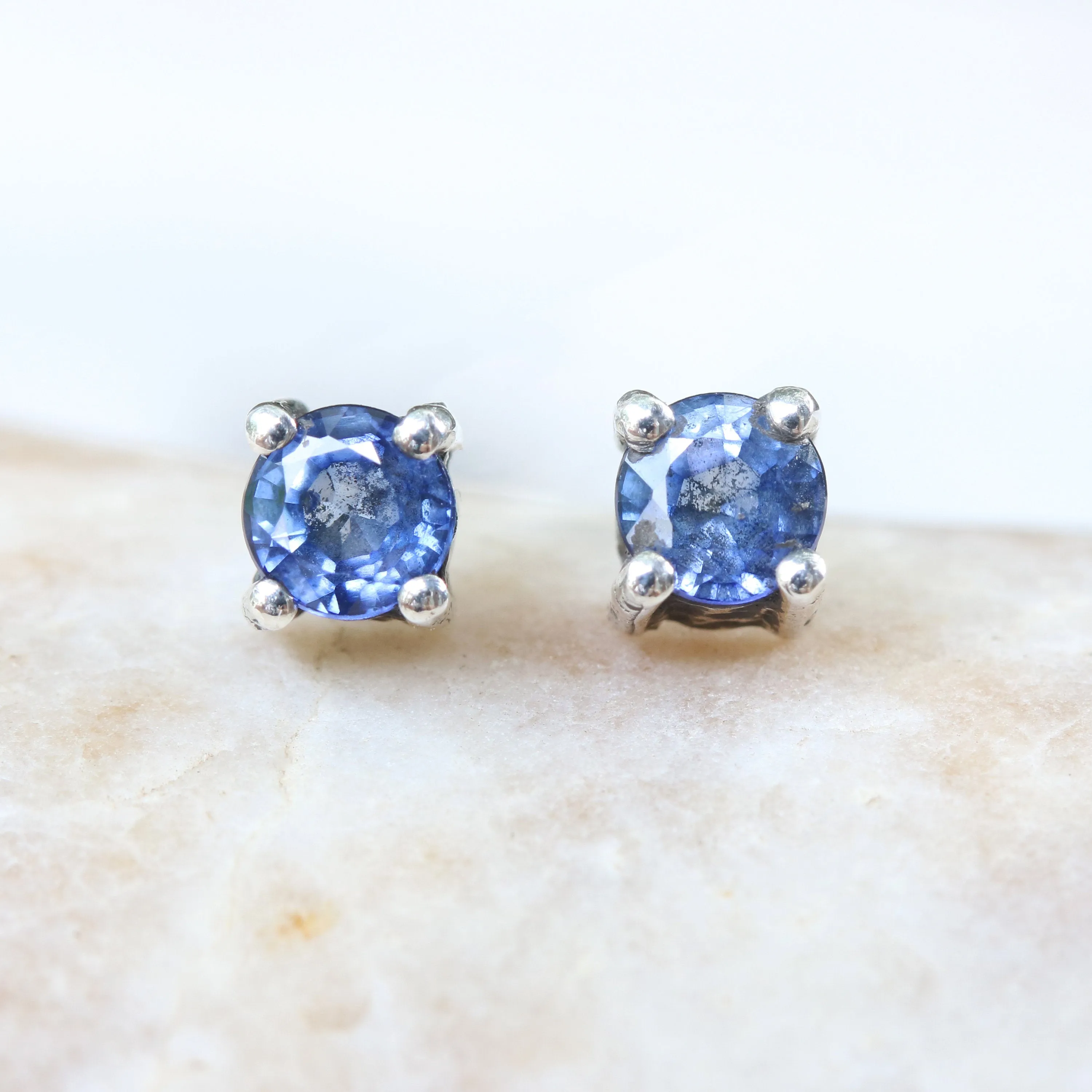 Sterling silver stud earrings with faceted blue sapphire in prongs setting with sterling silver post and backing