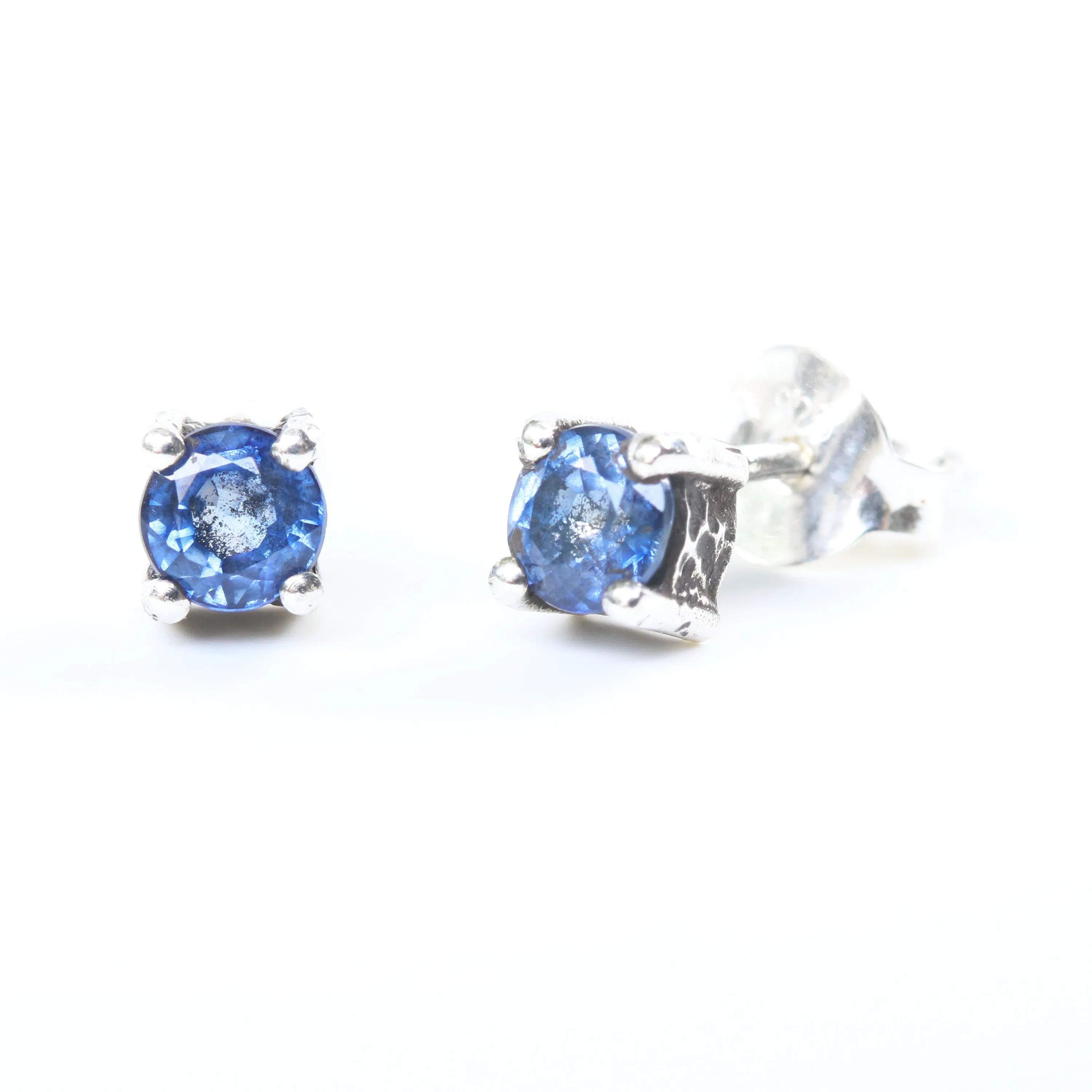 Sterling silver stud earrings with faceted blue sapphire in prongs setting with sterling silver post and backing
