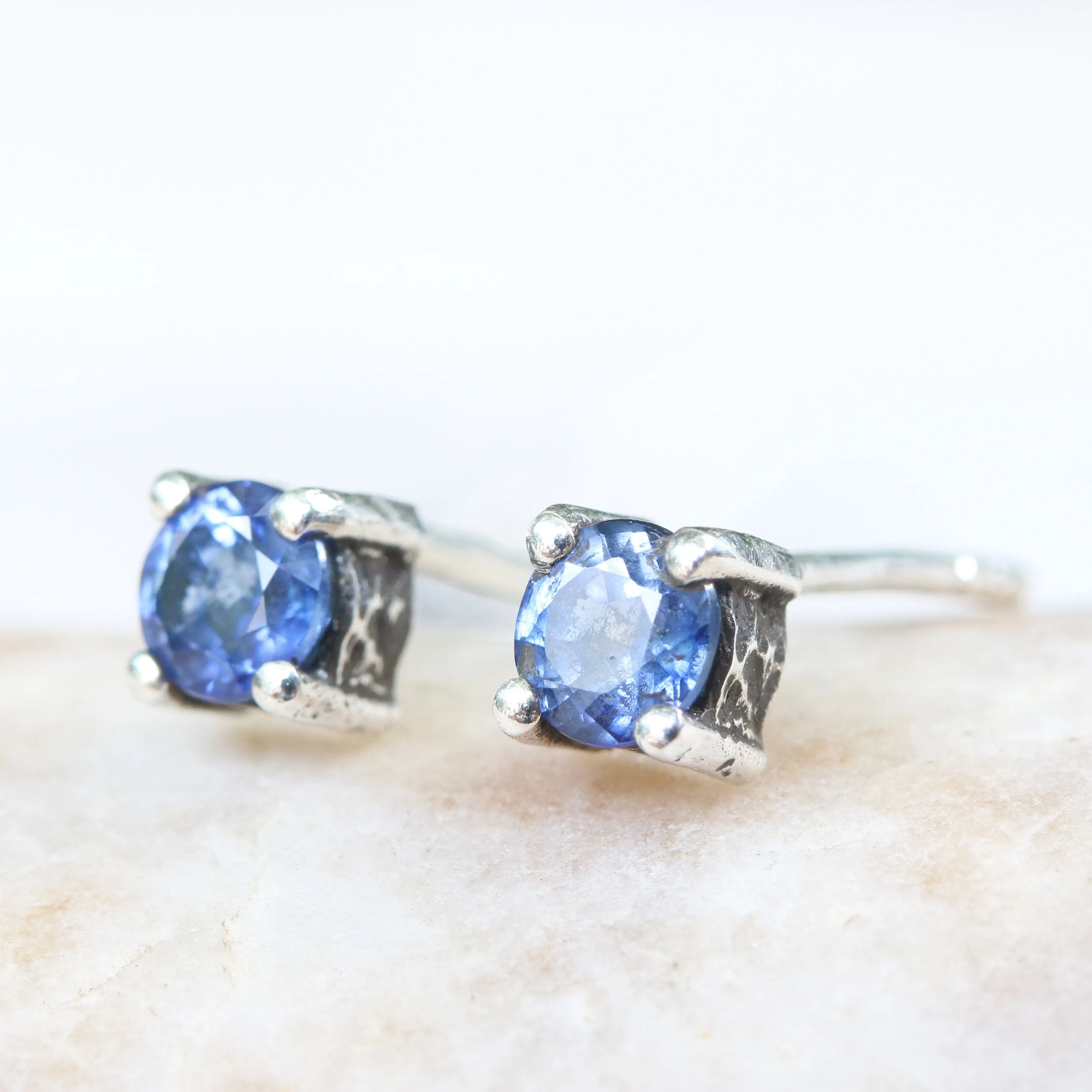 Sterling silver stud earrings with faceted blue sapphire in prongs setting with sterling silver post and backing