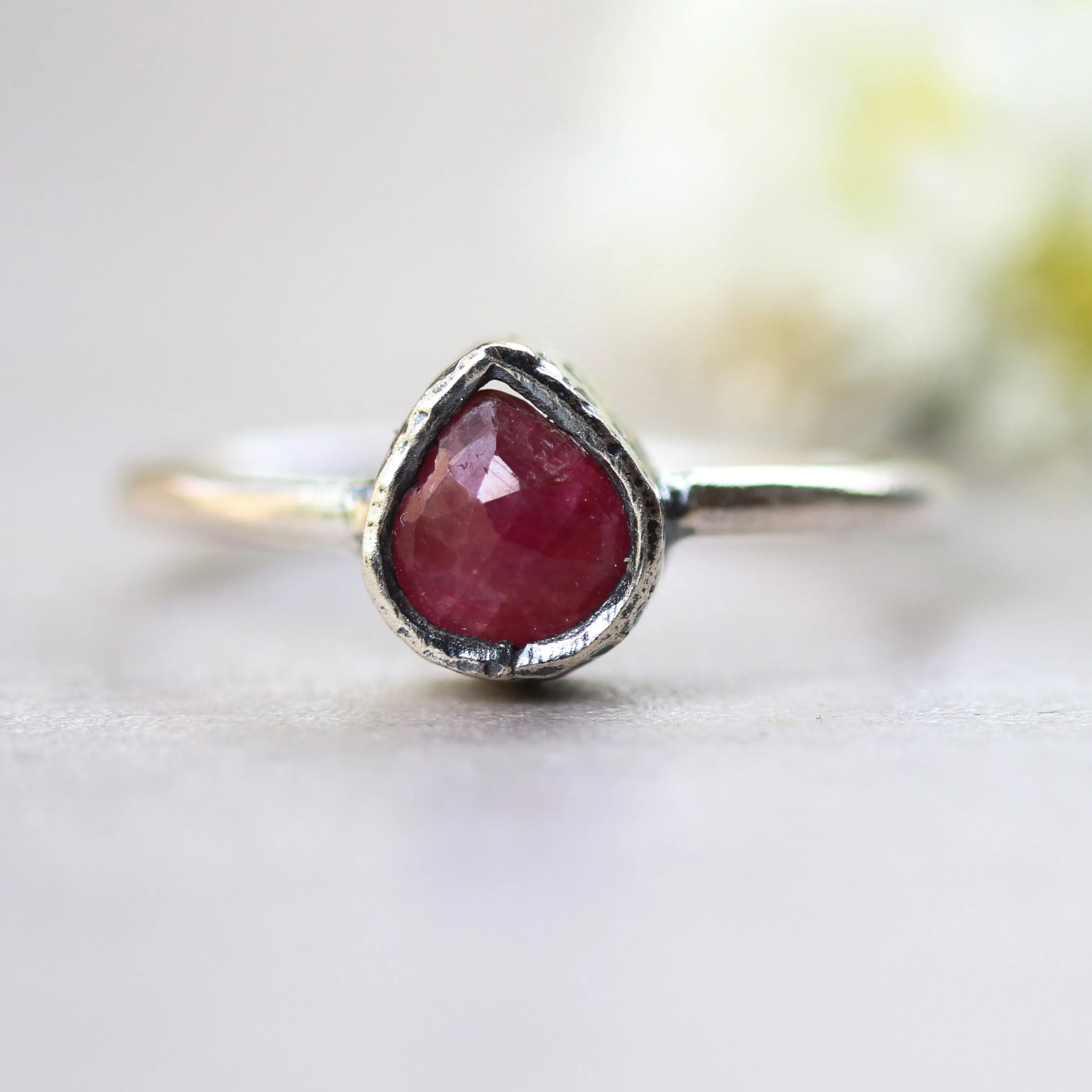 Teardrop ruby ring in silver bezel setting with sterling silver high polish finished band