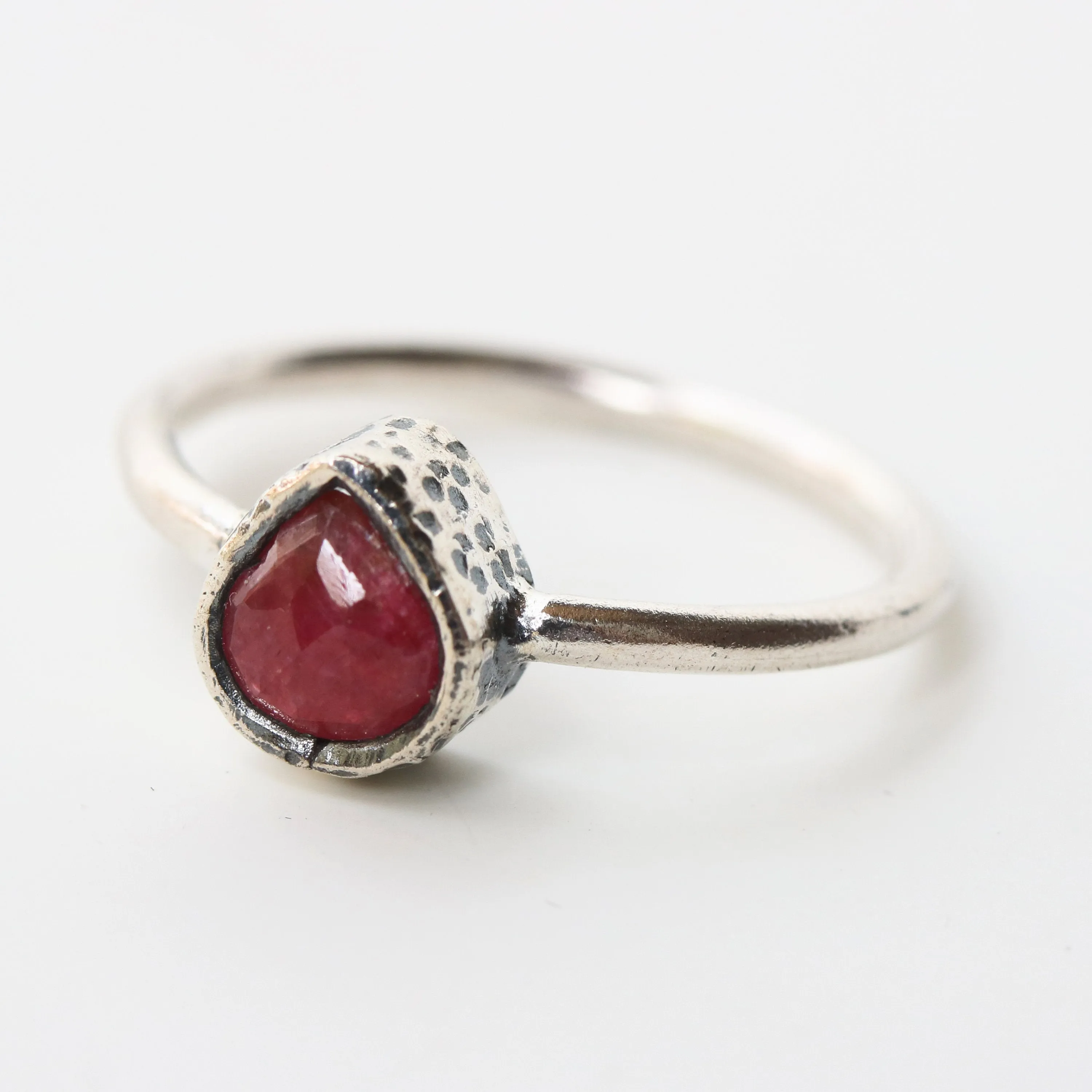 Teardrop ruby ring in silver bezel setting with sterling silver high polish finished band
