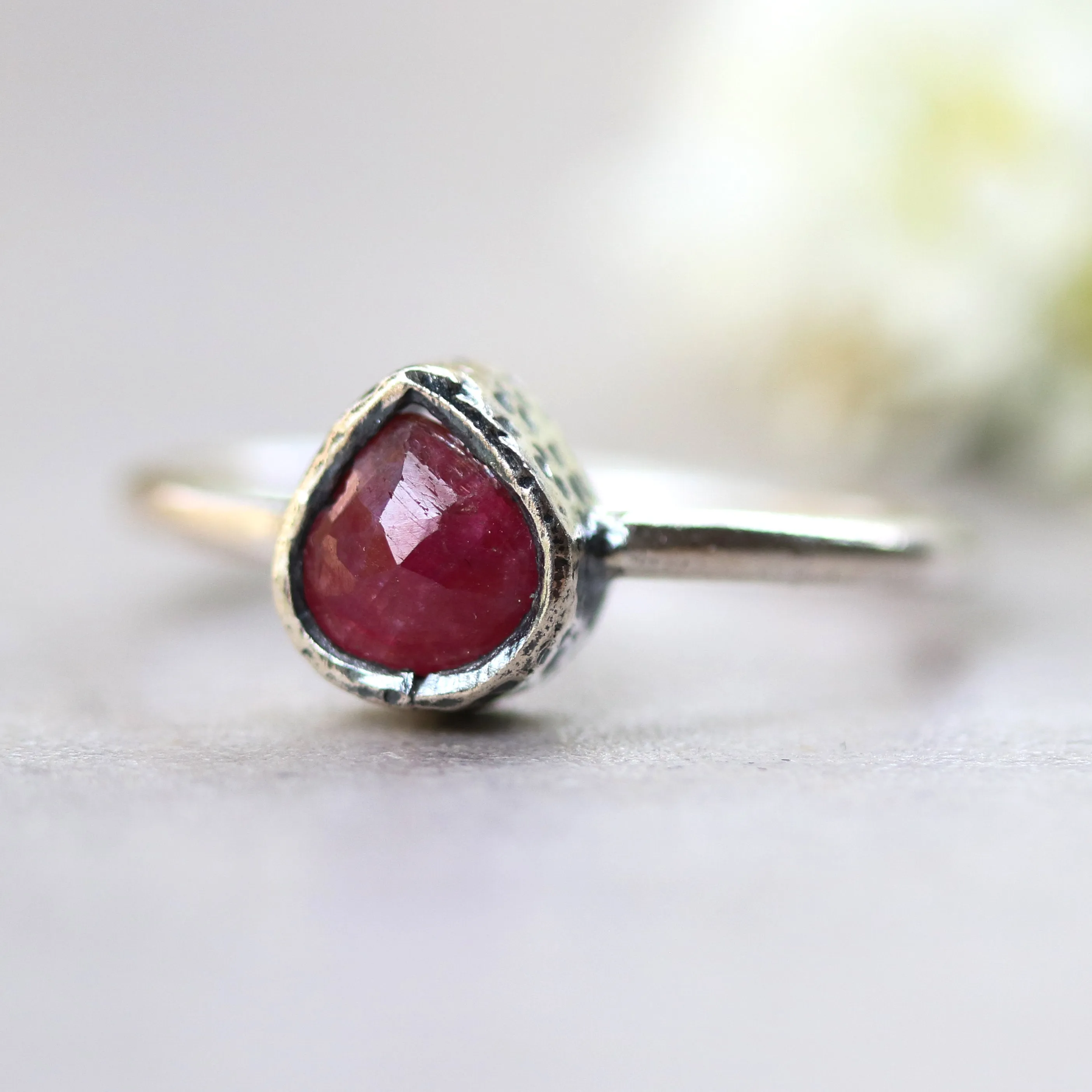 Teardrop ruby ring in silver bezel setting with sterling silver high polish finished band