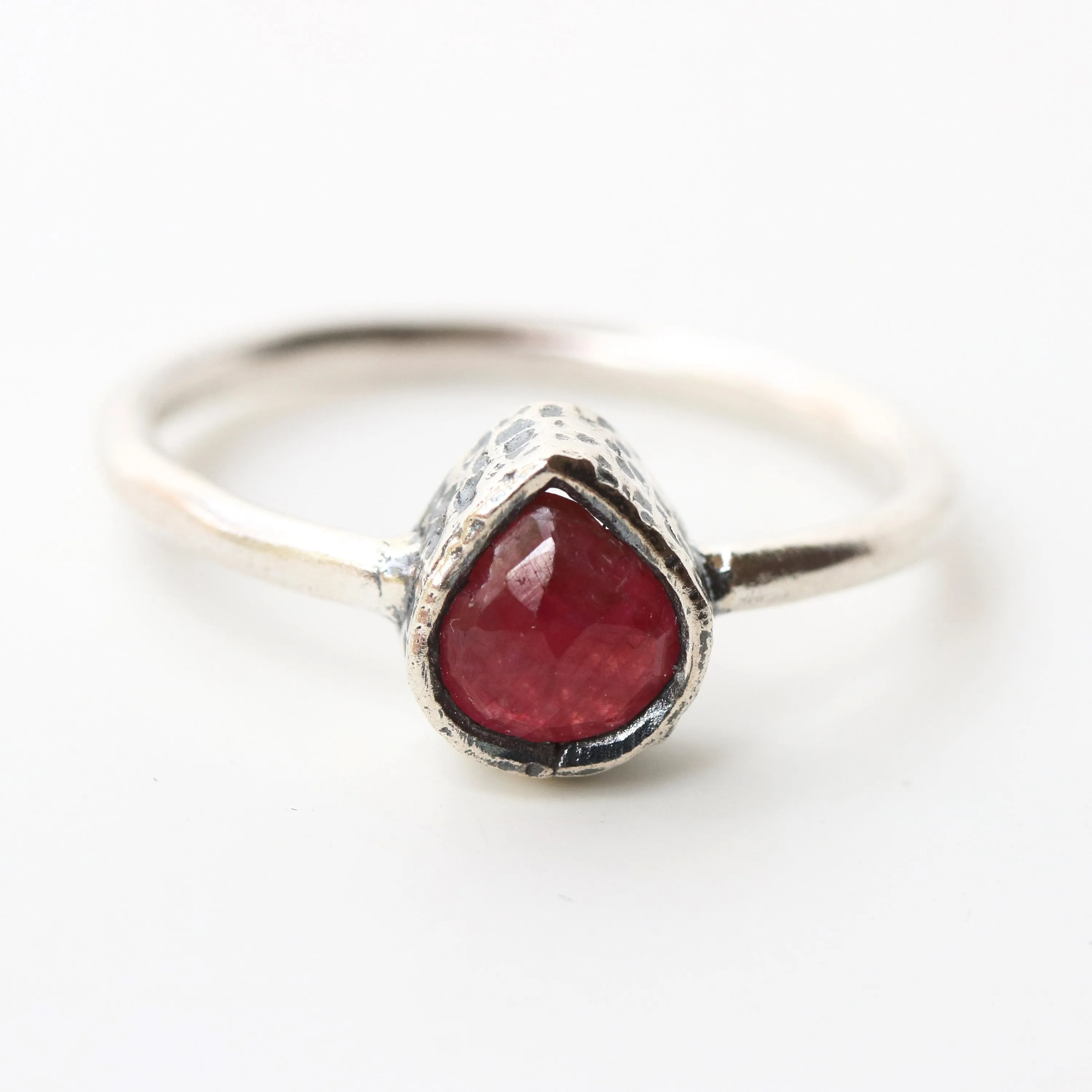 Teardrop ruby ring in silver bezel setting with sterling silver high polish finished band